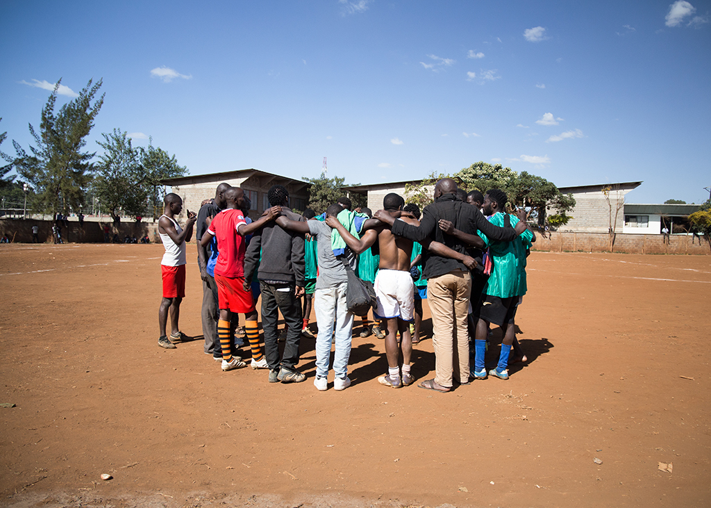 people in circle football pitch