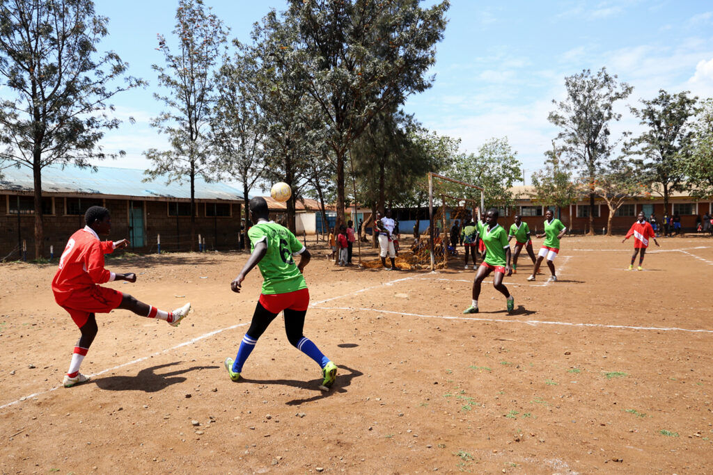 young girls play football